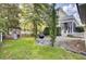 Charming backyard features a stone patio, green grass, grill, playset, and view of the screened in porch at 3302 Porchview Pl, Johns Island, SC 29455
