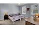 Well-lit bedroom with a twin bed, two windows with bright natural light, and a wooden desk at 3302 Porchview Pl, Johns Island, SC 29455