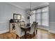 Charming dining room with hardwood floors, chandelier, and large windows at 3302 Porchview Pl, Johns Island, SC 29455
