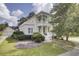 Charming two-story home featuring a double porch, manicured lawn, and lush landscaping creating a welcoming curb appeal at 3302 Porchview Pl, Johns Island, SC 29455