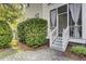 Exterior of a home with gray stairs and a bush in the front yard at 3302 Porchview Pl, Johns Island, SC 29455