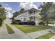 Inviting two-story home with a charming yellow exterior, lush landscaping, and a spacious driveway leading to the garage at 3302 Porchview Pl, Johns Island, SC 29455