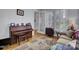 Bright home office with hardwood flooring, piano, and comfortable seating at 3302 Porchview Pl, Johns Island, SC 29455