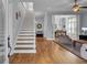 Spacious living room featuring an open floor plan, hardwood floors, and staircase at 3302 Porchview Pl, Johns Island, SC 29455