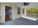 Inviting covered porch featuring a ceiling fan, white railing, and view of lush greenery at 3302 Porchview Pl, Johns Island, SC 29455