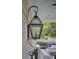 Close up of hanging porch lantern in front of a seating area at 3302 Porchview Pl, Johns Island, SC 29455