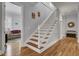 Elegant staircase with wooden steps and white railing at 3302 Porchview Pl, Johns Island, SC 29455