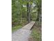 Wooden walking trail winding through lush greenery and mature trees at 3302 Porchview Pl, Johns Island, SC 29455