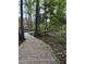 Wooden walking trail winding through lush greenery and mature trees at 3302 Porchview Pl, Johns Island, SC 29455
