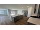 Modern kitchen boasts gray cabinets, stainless appliances, a large kitchen island and open floor plan at 334 Blue Haw Dr, Moncks Corner, SC 29461