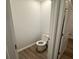 Compact powder room showcasing a toilet, white trim, neutral wall color, and wood-look flooring at 334 Blue Haw Dr, Moncks Corner, SC 29461