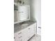 Bathroom vanity with marble countertop, modern fixtures, and marble floors at 45 Sycamore Ave # 1327, Charleston, SC 29407