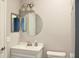 Bathroom featuring a vanity with storage, toilet, and a modern, circular mirror at 45 Sycamore Ave # 1327, Charleston, SC 29407