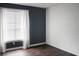 This bedroom features a trendy dark wall, white trim, and wood-look flooring at 45 Sycamore Ave # 1327, Charleston, SC 29407
