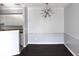 Contemporary dining room with dark wood floors and a decorative light fixture at 45 Sycamore Ave # 1327, Charleston, SC 29407