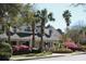 Beautiful home with lush landscaping featuring colorful azaleas, palm trees and a covered porch at 45 Sycamore Ave # 1327, Charleston, SC 29407