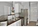 Galley kitchen boasts stainless steel appliances, wood countertops, and white cabinetry at 45 Sycamore Ave # 1327, Charleston, SC 29407