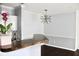 View from kitchen bar to dining area with an ornate chandelier and wood flooring at 45 Sycamore Ave # 1327, Charleston, SC 29407