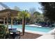 Community pool and surrounding deck featuring plenty of seating and shade at 45 Sycamore Ave # 1327, Charleston, SC 29407