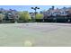 Outdoor tennis courts are surrounded by community buildings and mature trees and shrubbery at 45 Sycamore Ave # 1327, Charleston, SC 29407