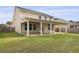 This backyard features a covered patio, perfect for outdoor entertaining and enjoying the view of the green lawn at 470 Gianna Ln, Goose Creek, SC 29445