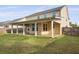 This backyard features a covered patio, perfect for outdoor entertaining and enjoying the view of the green lawn at 470 Gianna Ln, Goose Creek, SC 29445