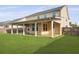 This backyard features a covered patio, perfect for outdoor entertaining and enjoying the view of the green lawn at 470 Gianna Ln, Goose Creek, SC 29445