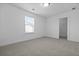 A carpeted bedroom with a window with blinds and a doorway to a walk-in closet at 470 Gianna Ln, Goose Creek, SC 29445