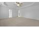 Large carpeted bedroom with ceiling fan, tray ceiling, and two entry doors at 470 Gianna Ln, Goose Creek, SC 29445