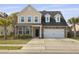 Charming two-story home featuring a stone and vinyl facade, attached garage, and well-maintained lawn at 470 Gianna Ln, Goose Creek, SC 29445