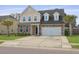Charming two-story home featuring a stone and vinyl facade, attached garage, and well-maintained lawn at 470 Gianna Ln, Goose Creek, SC 29445