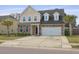 Charming two-story home featuring a stone and vinyl facade, attached garage, and well-maintained lawn at 470 Gianna Ln, Goose Creek, SC 29445