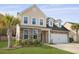 Charming two-story home featuring a stone and vinyl facade, attached garage, and a well-manicured lawn at 470 Gianna Ln, Goose Creek, SC 29445
