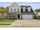 Charming two-story home featuring a stone and vinyl facade, attached garage, and well-maintained lawn at 470 Gianna Ln, Goose Creek, SC 29445