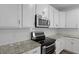 White kitchen with stainless steel microwave and oven at 470 Gianna Ln, Goose Creek, SC 29445
