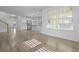 Bright open-concept living area with wood floors, large windows, and a view of the kitchen at 470 Gianna Ln, Goose Creek, SC 29445