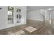 Bright living room boasts hardwood floors and natural light from French doors at 470 Gianna Ln, Goose Creek, SC 29445