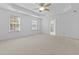 Large carpeted main bedroom with ceiling fan, tray ceiling, and natural light at 470 Gianna Ln, Goose Creek, SC 29445