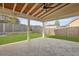 Covered patio with stamped concrete, ceiling fan, wood ceiling and an outdoor backyard view at 470 Gianna Ln, Goose Creek, SC 29445
