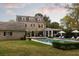 A gorgeous home featuring a pool, outdoor kitchen, lounge chairs, and an expansive lush lawn at 478 Huger St, Charleston, SC 29403