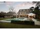 An outdoor oasis featuring a pool, lush lawn, an outdoor kitchen, lounge chairs, and a meticulously landscaped backyard at 478 Huger St, Charleston, SC 29403