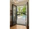 Inviting backyard with a pool, lounge chairs under umbrellas, and a well-manicured lawn, viewed from inside at 478 Huger St, Charleston, SC 29403