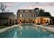 Beautiful backyard pool with lounge chairs and an outdoor seating area at dusk at 478 Huger St, Charleston, SC 29403