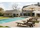 Beautiful backyard with a swimming pool, lounge chairs, and a stone garage, perfect for outdoor living at 478 Huger St, Charleston, SC 29403
