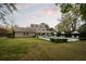 Expansive backyard featuring a swimming pool, stone facade, outdoor kitchen, lounge chairs, and landscaped lawn at 478 Huger St, Charleston, SC 29403