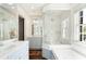 Luxurious bathroom with dual vanities, a soaking tub, and a separate glass-enclosed shower at 478 Huger St, Charleston, SC 29403