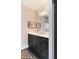 Stylish powder room featuring a black vanity with crystal knobs, a large mirror, and modern lighting fixtures at 478 Huger St, Charleston, SC 29403
