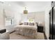Bright bedroom with a king bed, neutral bedding, decorative pillows, two windows, and stylish bedside tables at 478 Huger St, Charleston, SC 29403
