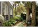 Charming courtyard with a stone fountain, black iron gate, and lush plants creating a serene outdoor space at 478 Huger St, Charleston, SC 29403