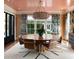 Cozy dining room with round table, designer light fixture, and verdant decorative accents at 478 Huger St, Charleston, SC 29403